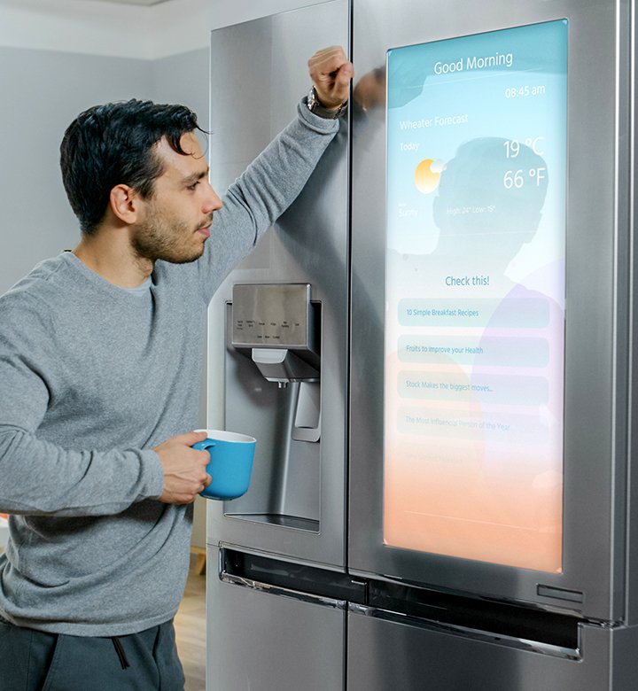 man looking at smart fridge screen