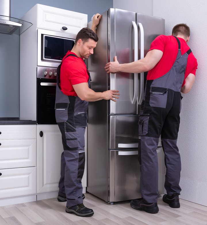 tradesmen fitting a fridge