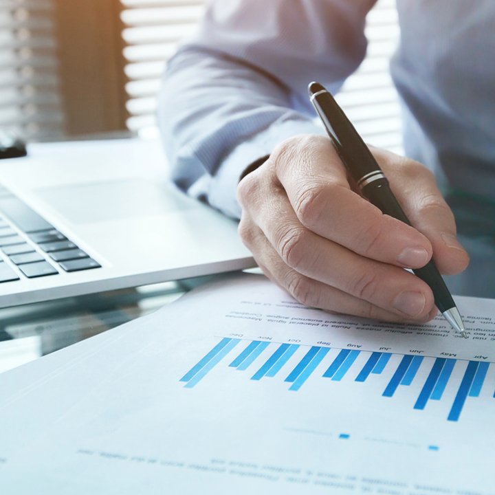 Man holding a pen working on a report